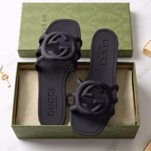 Gucci Palma black slide sandals displayed in their original Gucci box styled with fine jewelry